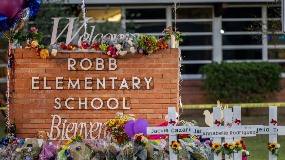 A memorial by a 'Robb Elementary School' sign in Uvalde, Texas.