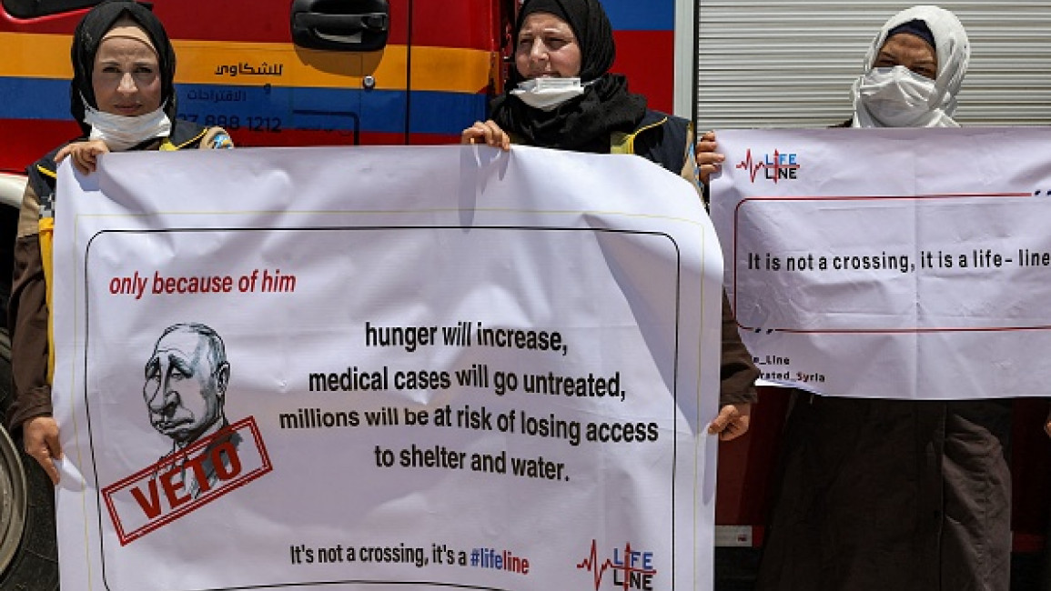 Humanitarian aid workers demonstrate against the closure of the Bab al-Hawa