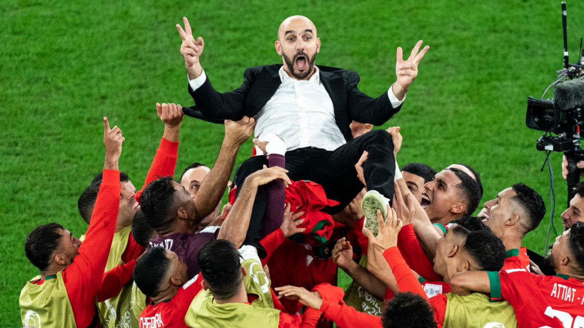 Morocco's head coach Walid Regragui is thrown in the air as Morocco players celebrate after winning the penalty shootout during their last 16 game against Spain [Getty Images]