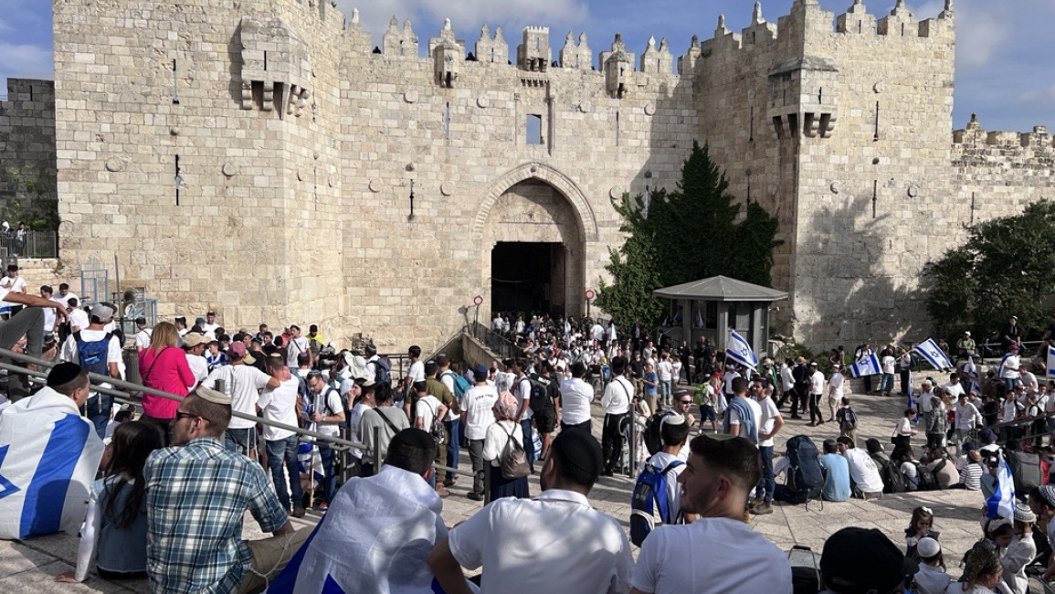 An image showing Israelis gathered with flags in front of an entrance to occupied East Jerusalem's Old City