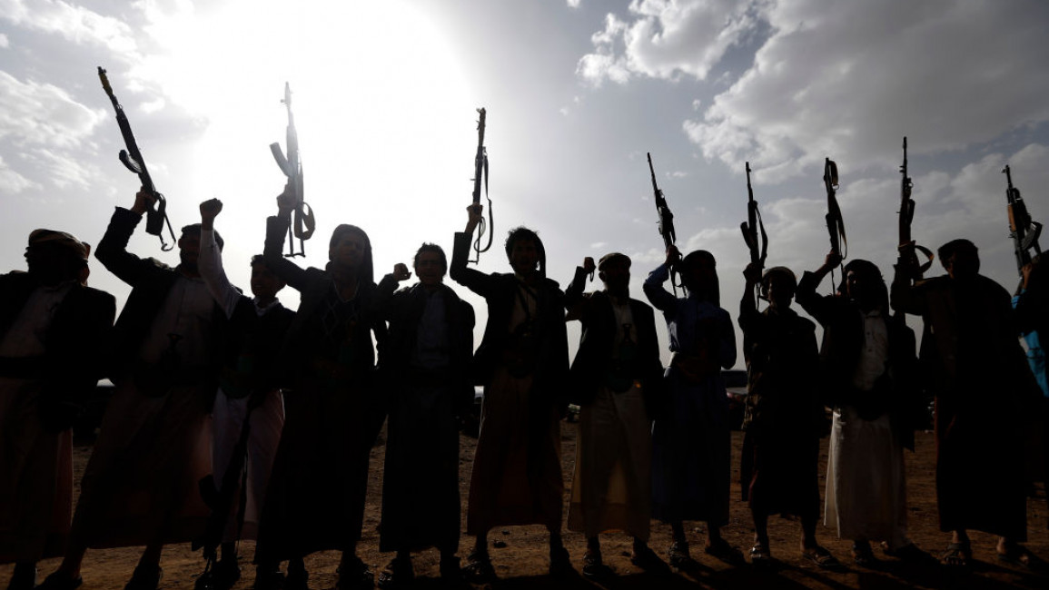 A group of Houthi rebels in Yemen, some pointing rifles in the air