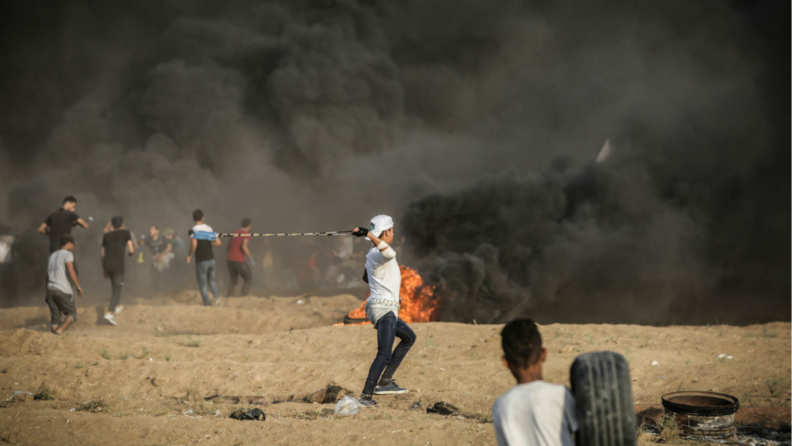Palestinian protester throwing a stone