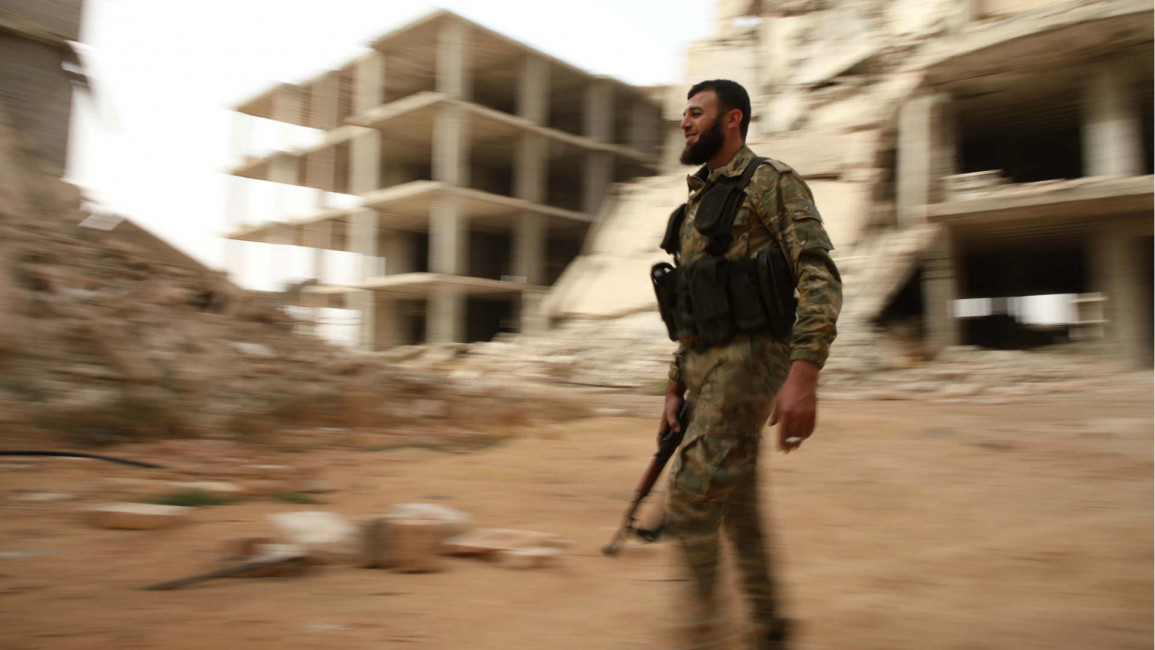Rebel Syrian fighter walking near Idlib province