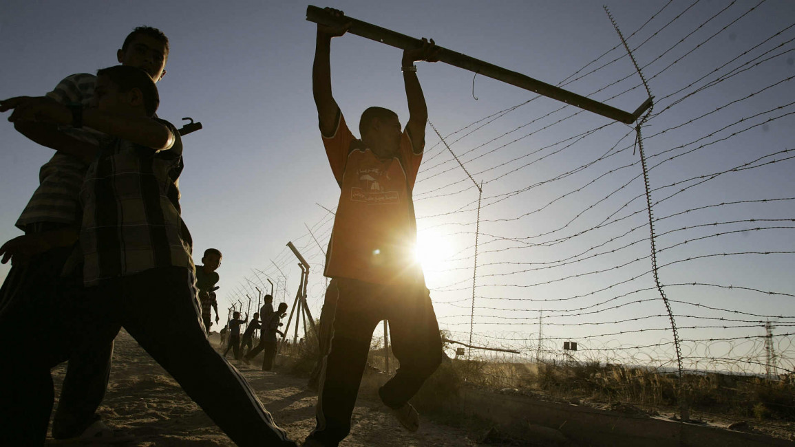 Palestinian boy tears down separation fence