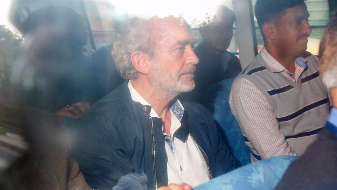 British national Christian Michel James (C), the alleged middleman