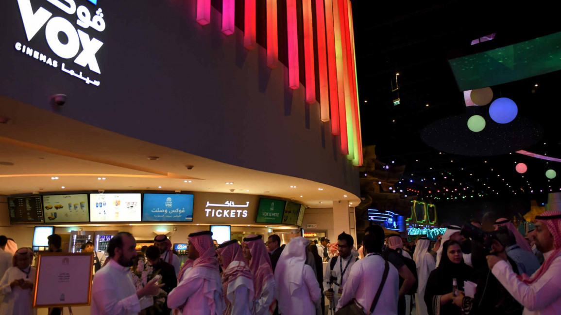 Saudis gather at a cinema after its opening