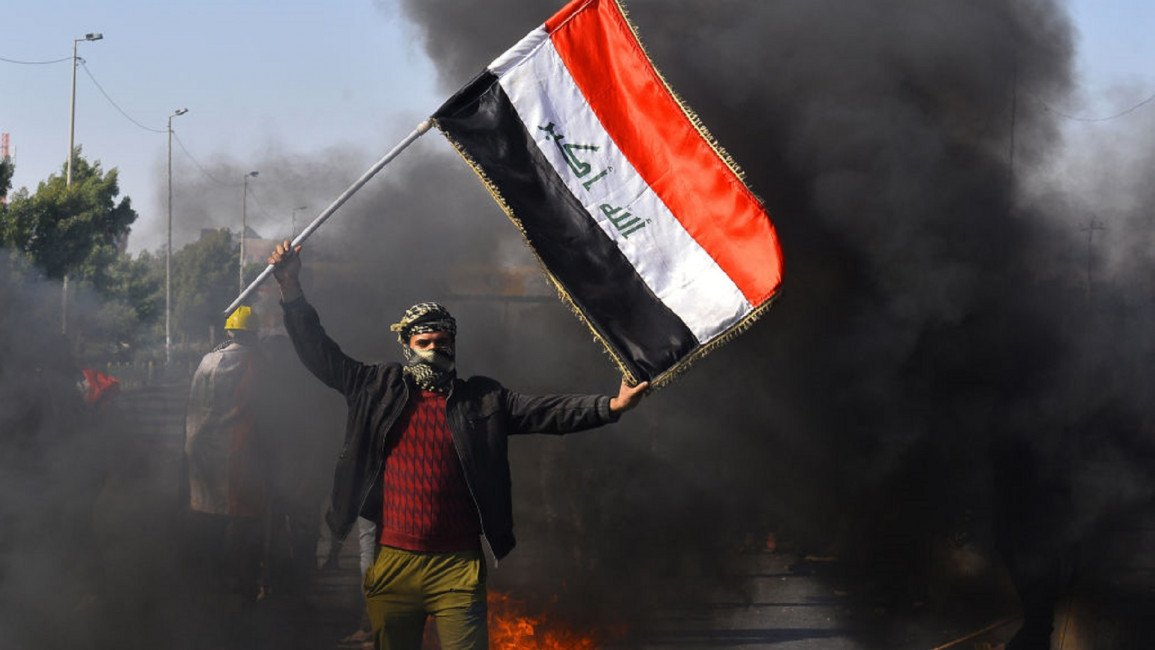  [GETTY]An Iraqi anti-government protester waves his national flag