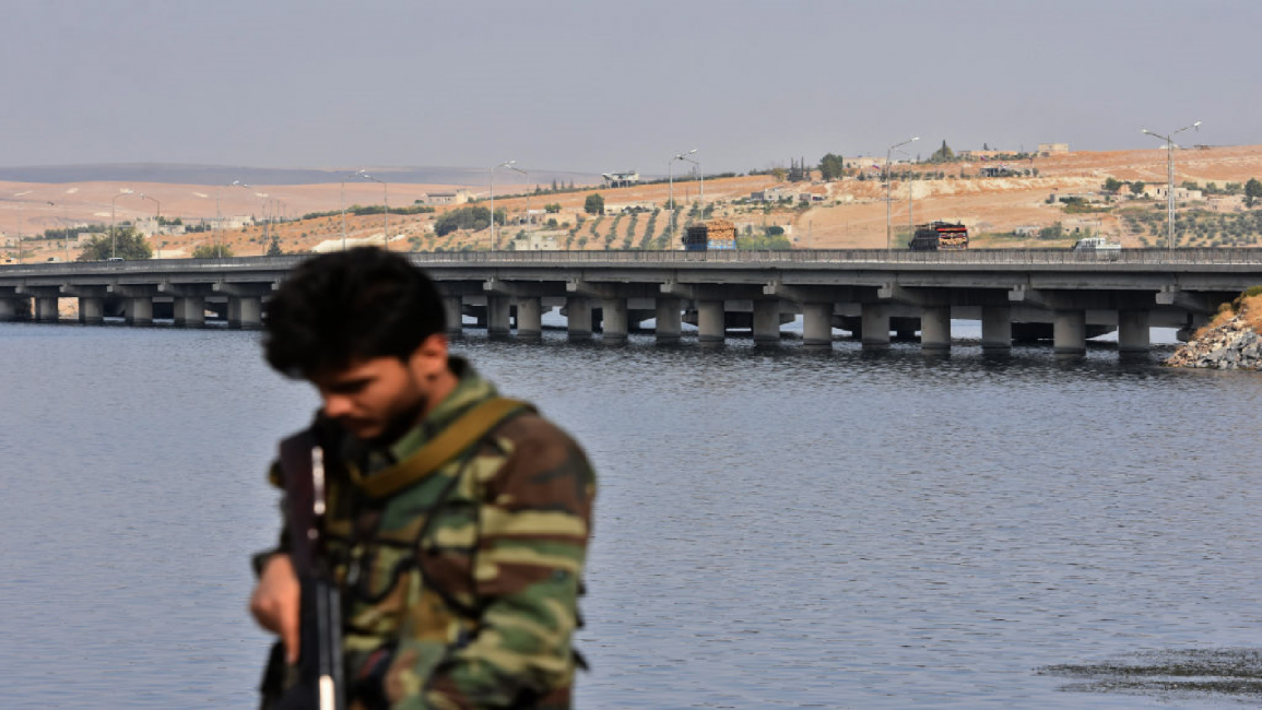 Syrian soldier walks along Euphrates River