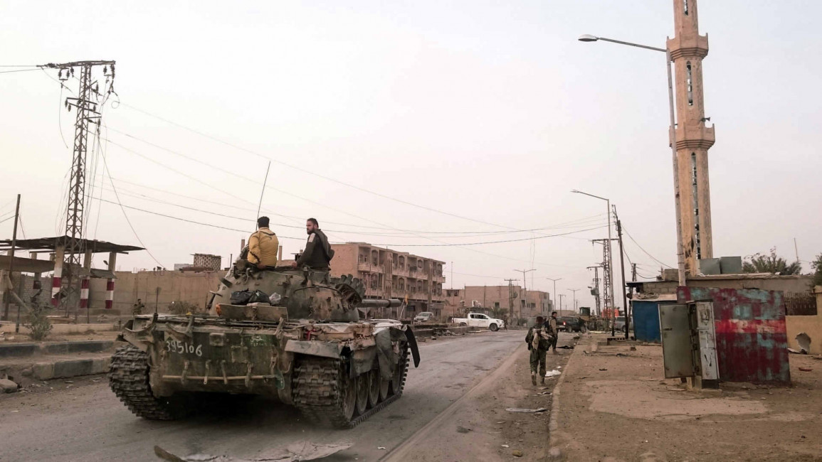 Pro-regime forces patrolling the Albu Kamal border town