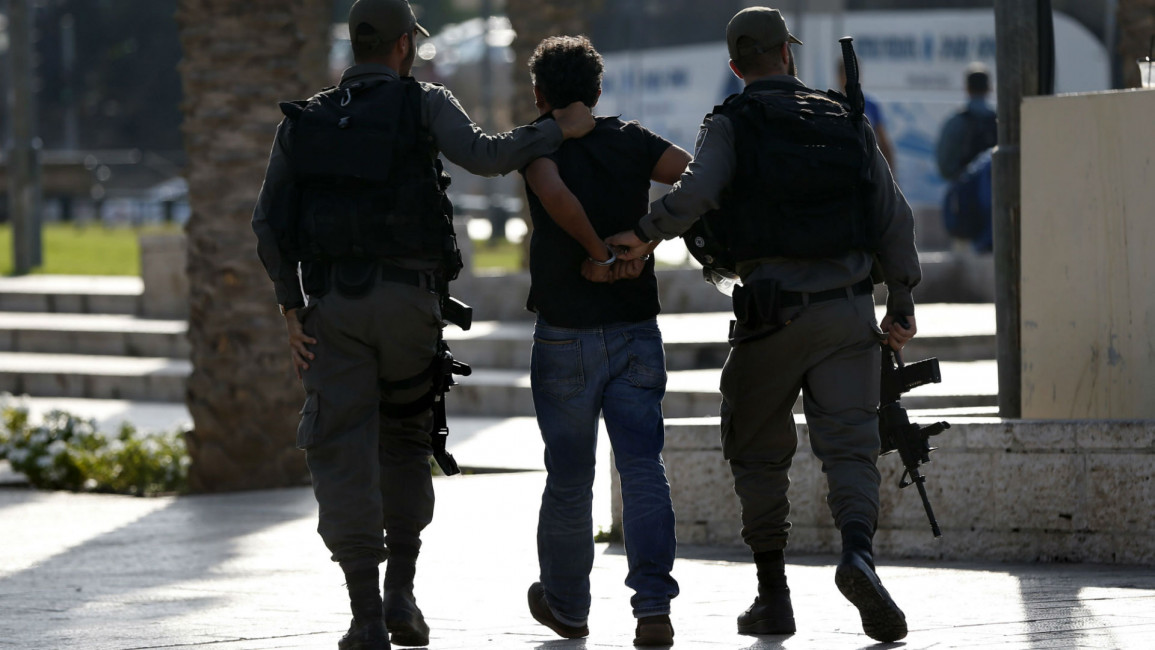 Israeli police arrest Palestinian [AFP]