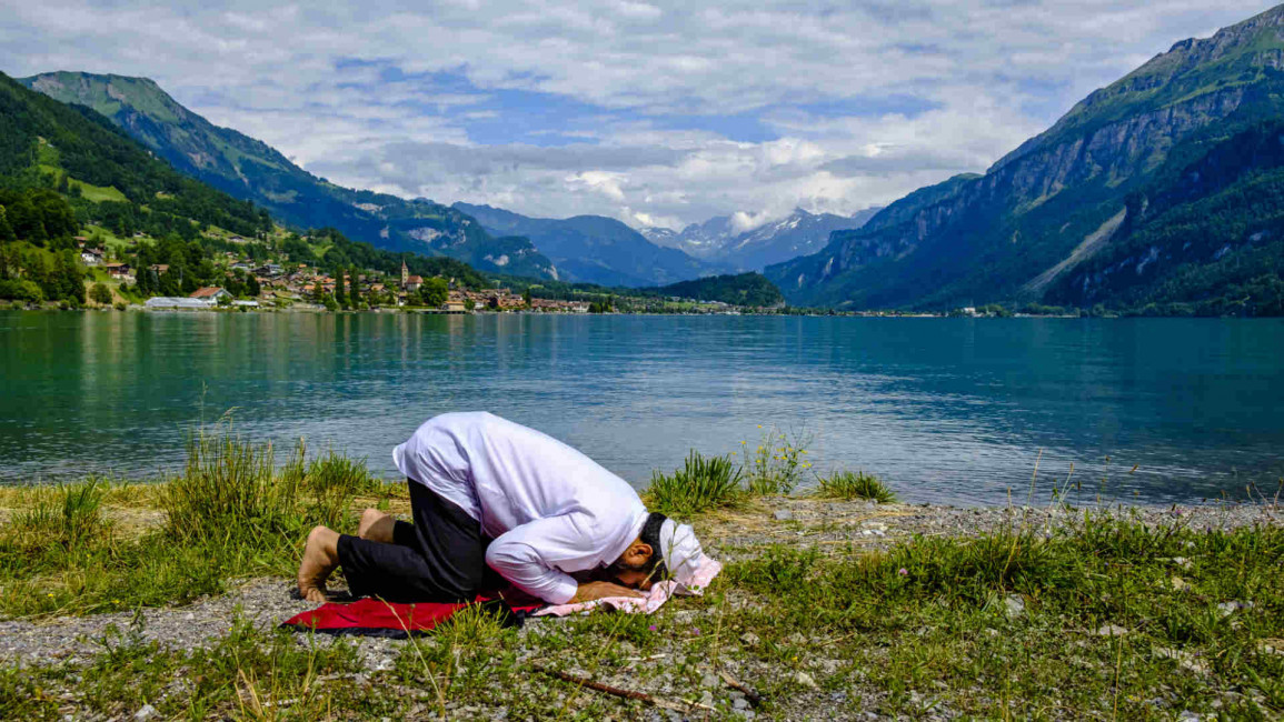 Muslim man praying in Switzerland - Lightrocket