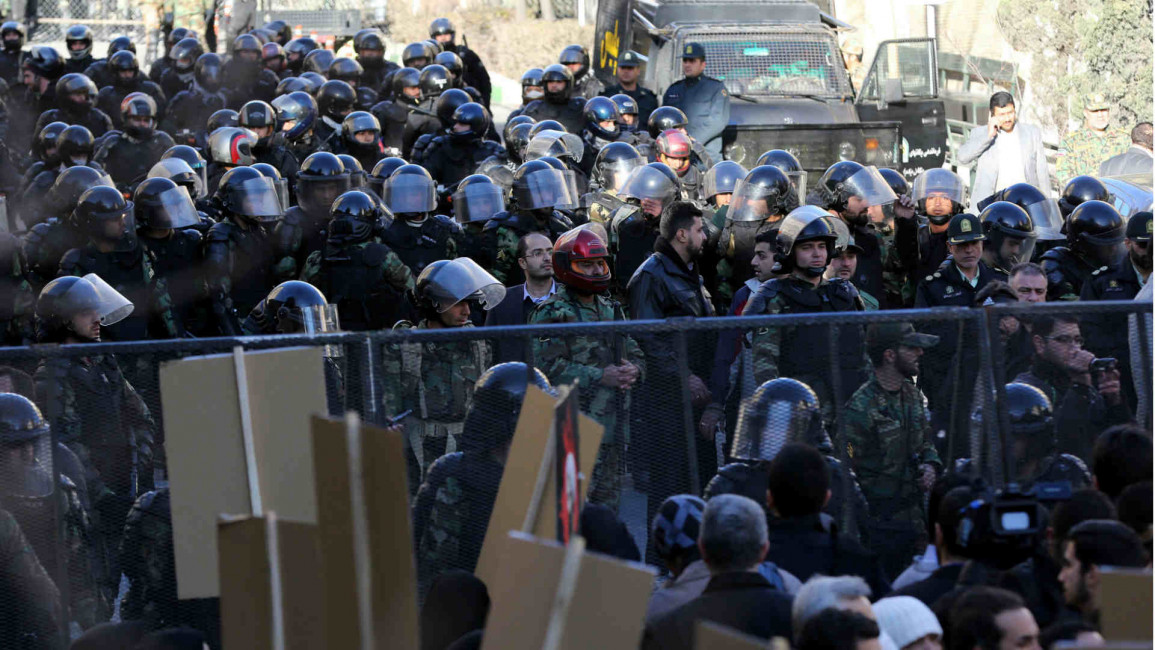 Iranian riot police stand guard as protests mount