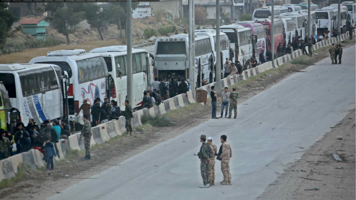 Syrian regime forces stand near as rebels evacuate