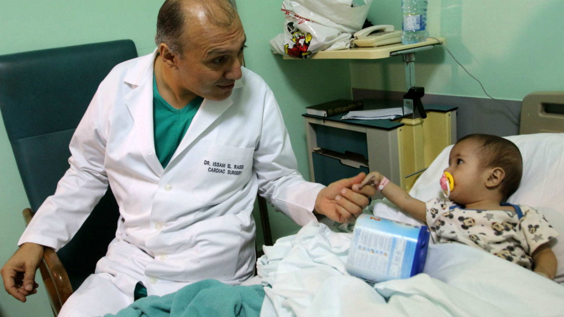 Peadetric surgeon with a Syrian refugee children