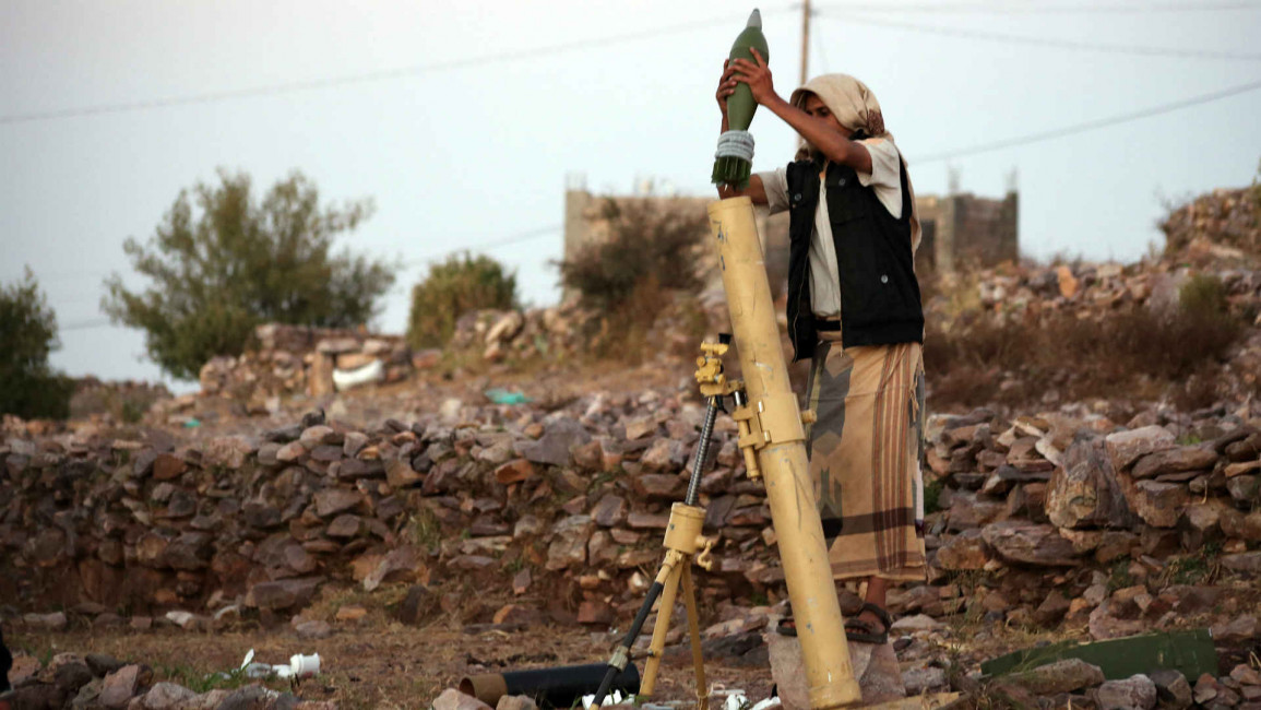 A Yemeni tribesmen launches a rocket