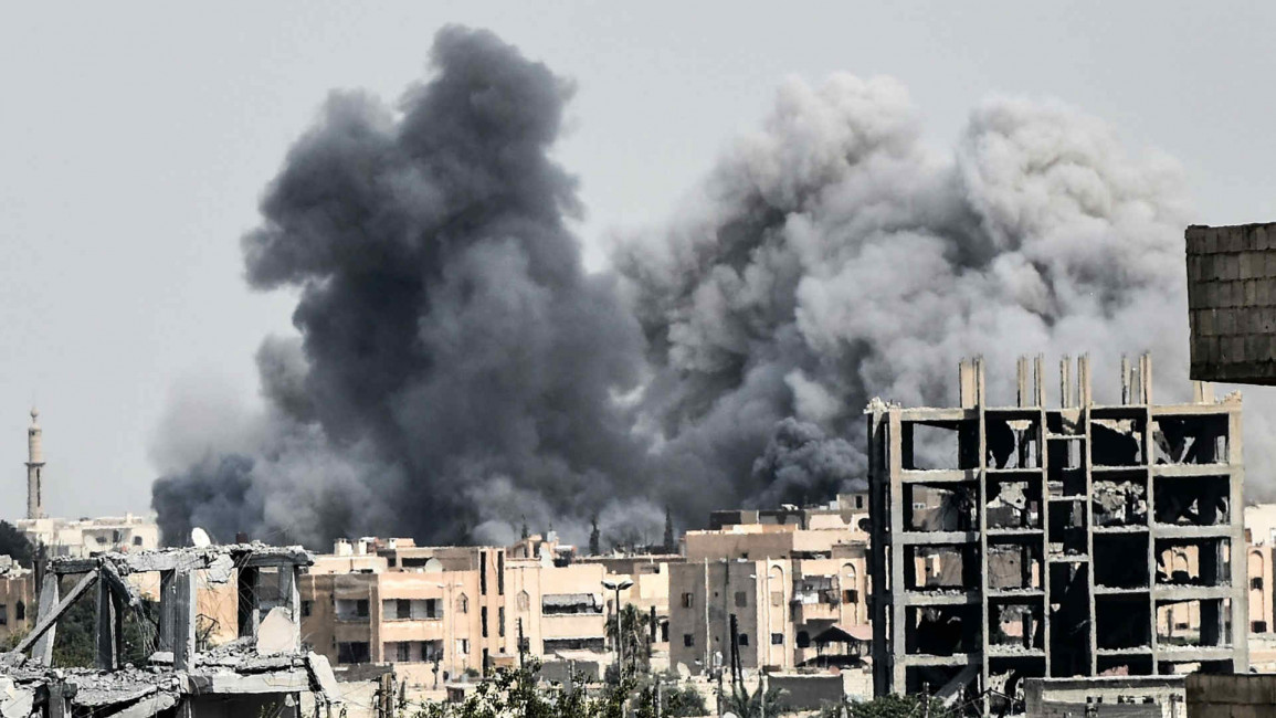 Heavy smoke billows following an airstrike in Raqqa