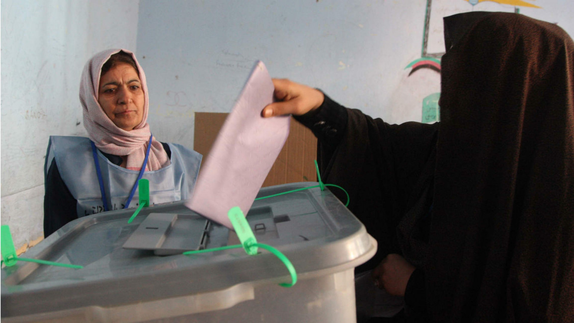 Afghan woman casts her vote at polling station
