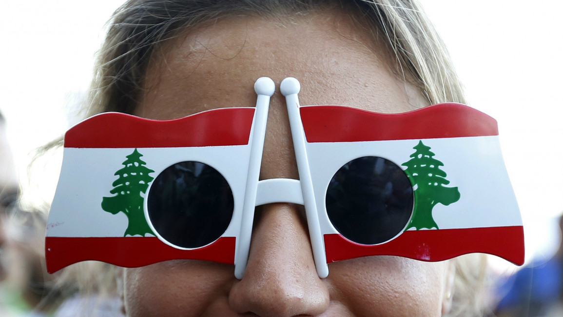 Lebanese protester sunglasses Lebanese flag