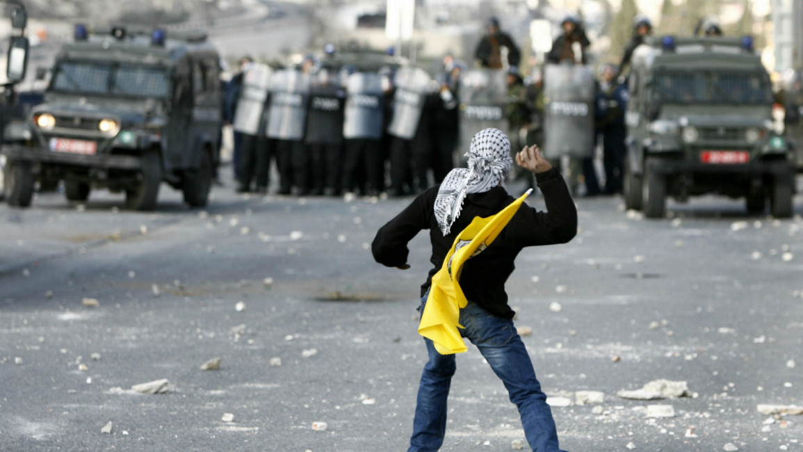 Palestinian youth throwing stones at Israeli forces [AFP]