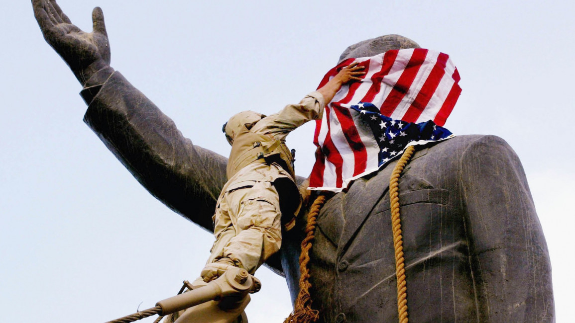 Saddam Statue falls - US flag - Getty