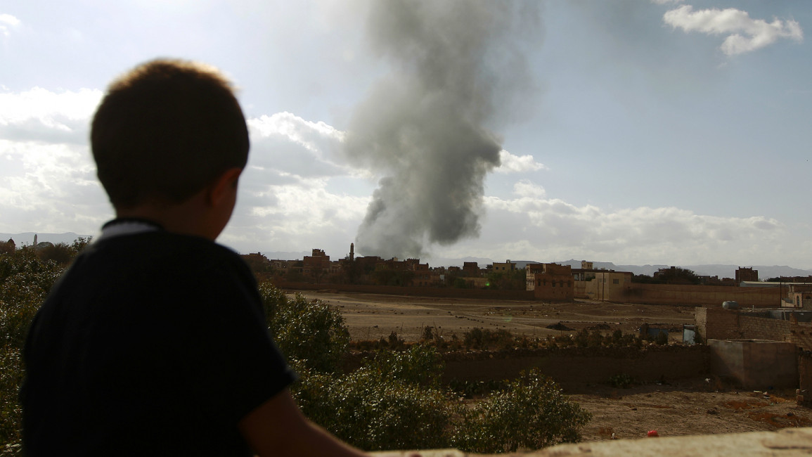 Yemen child watches smoke from airstrike