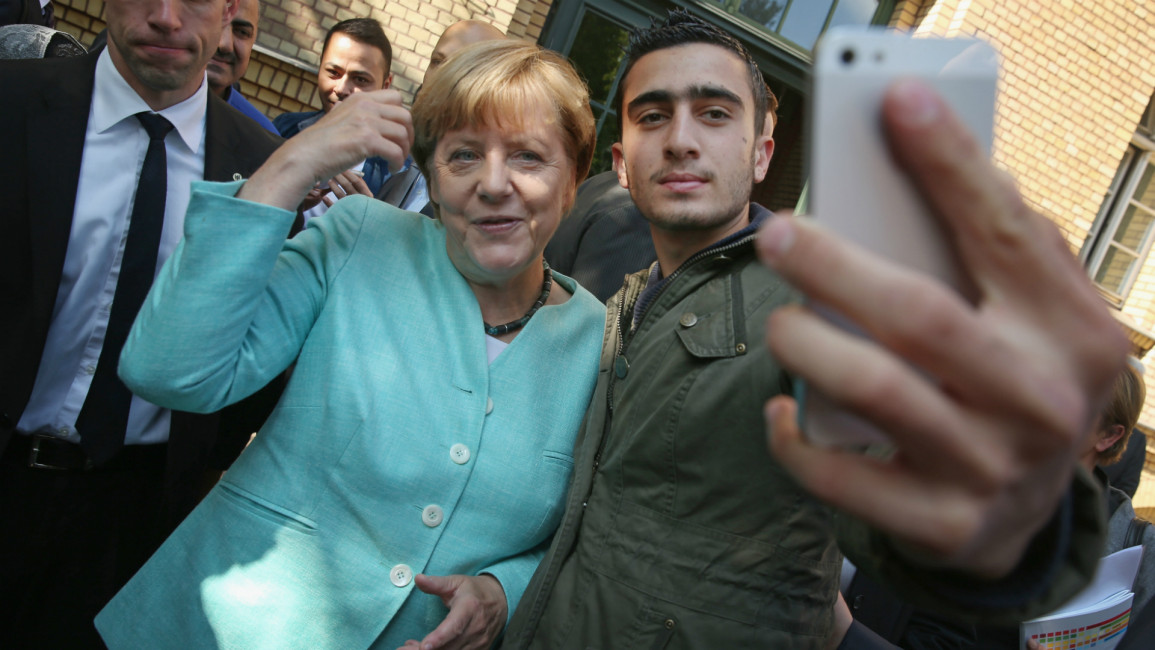 Angela Merkel poses for a selfie Syrian refugee 