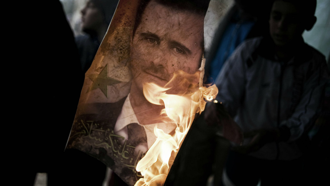 assad burning poster AFP