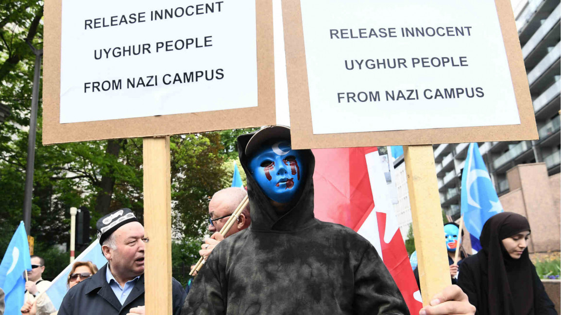 Ethnic Uighurs take part in a protest in Brussels