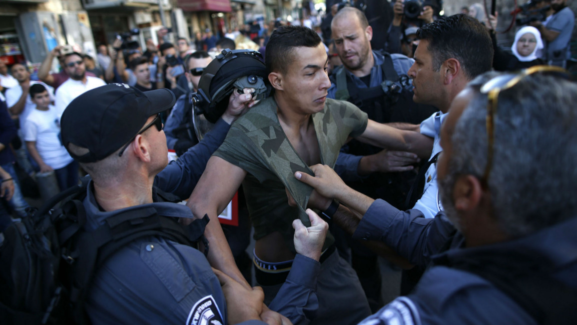 Israeli police assault Palestinian protesters [AFP]