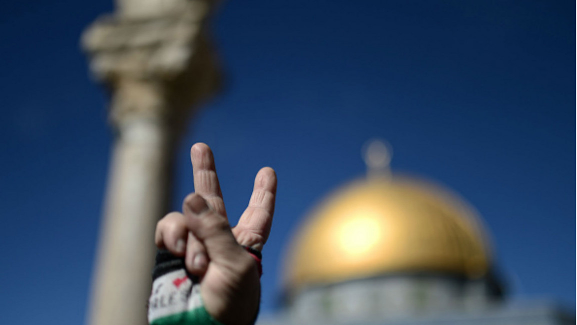 A Palestinian flashes a victory sign [Getty] 