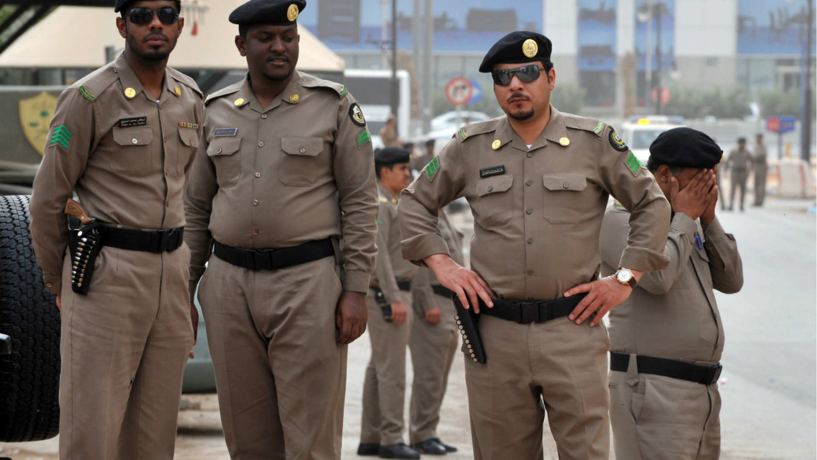 Saudi policemen stand guard