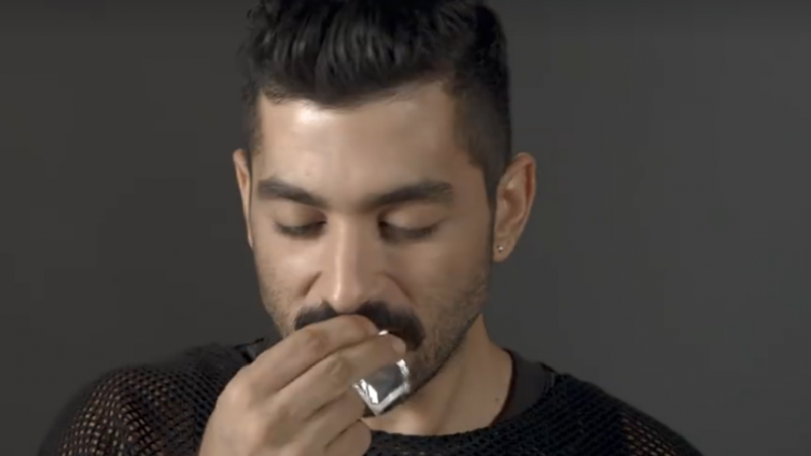 Hamed Sino showing how not open a condom [Facebook]