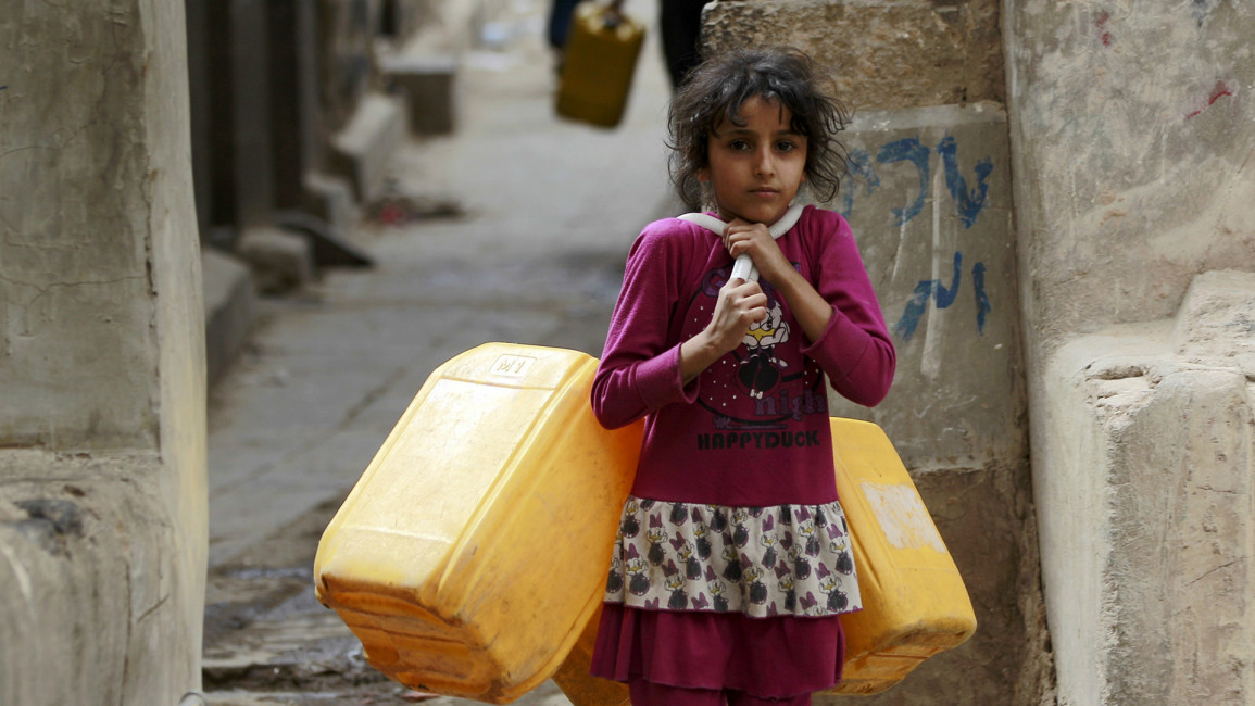 Yemeni girl with jerrycans