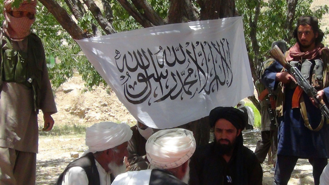 Taliban fighters speaking to residents in Afghanistan [Getty]