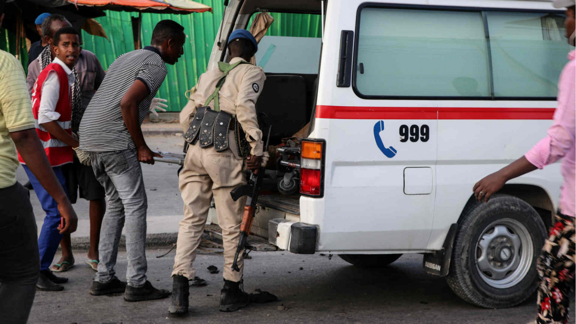 Ambulance arrive after twin car blasts in Mogadishu